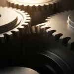 A cinematic, high-contrast photograph of a heavy metallic gear system slowly engaging, representing physical momentum. Warm morning light hitting the brushed steel textures, subtle dust motes floating in the air, macro photography style, highly detailed and atmospheric.