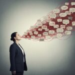 A conceptual illustration of over-explaining. A person stands calmly while a chaotic, tangled web of overlapping speech bubbles and red strings emanates from their mouth, fading into a muted gray background. Minimalist psychological art style, soft lighting.